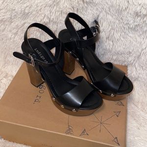 Never worn! Box kept.  Perfect condition, black platform with faux wood heel.
